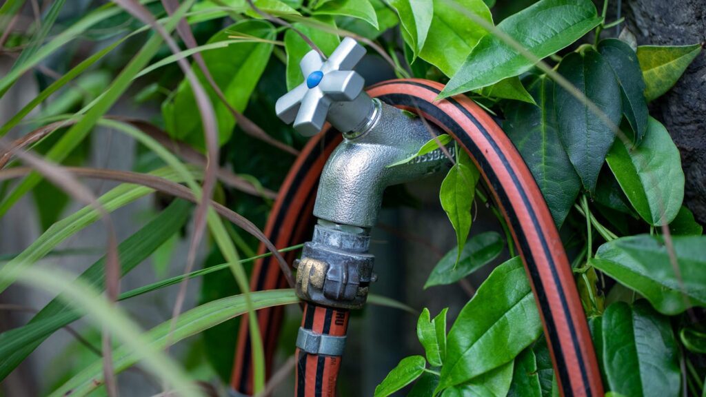 metal garden tap with hosepipe